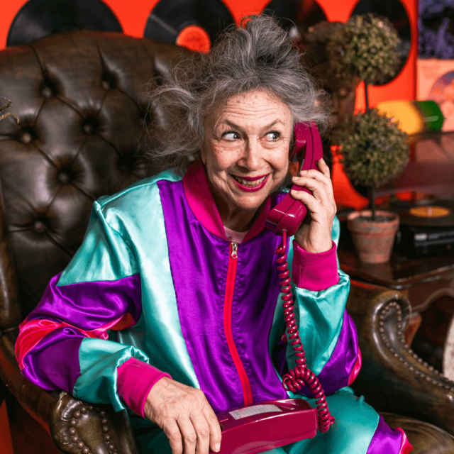 Old lady in very colorful trousers calling the best personal trainer in San Diego