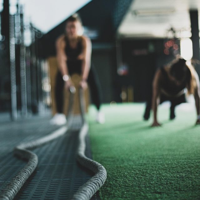 Two women working out with a combat rope