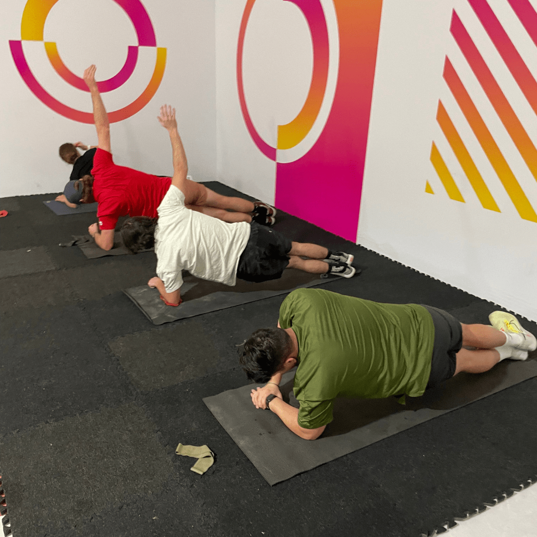 Corporate workout with four people planking