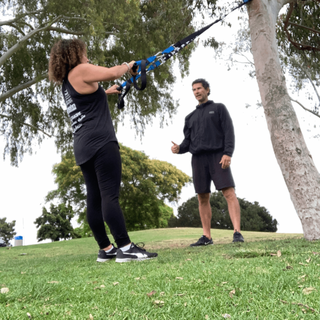 One on One Personal Training Session with the best personal trainer in San Diego and woman mid age using a trx