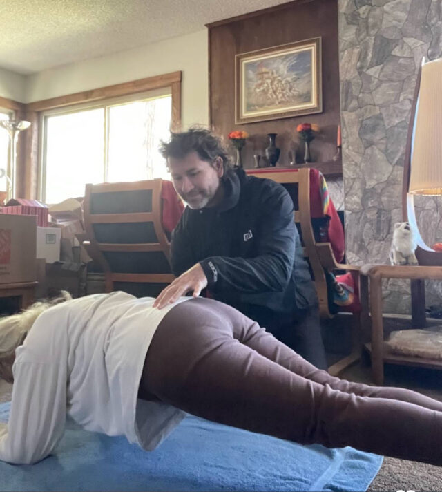 Marsha in a plank position during a guided personal training session focused on core strength and spinal stability.